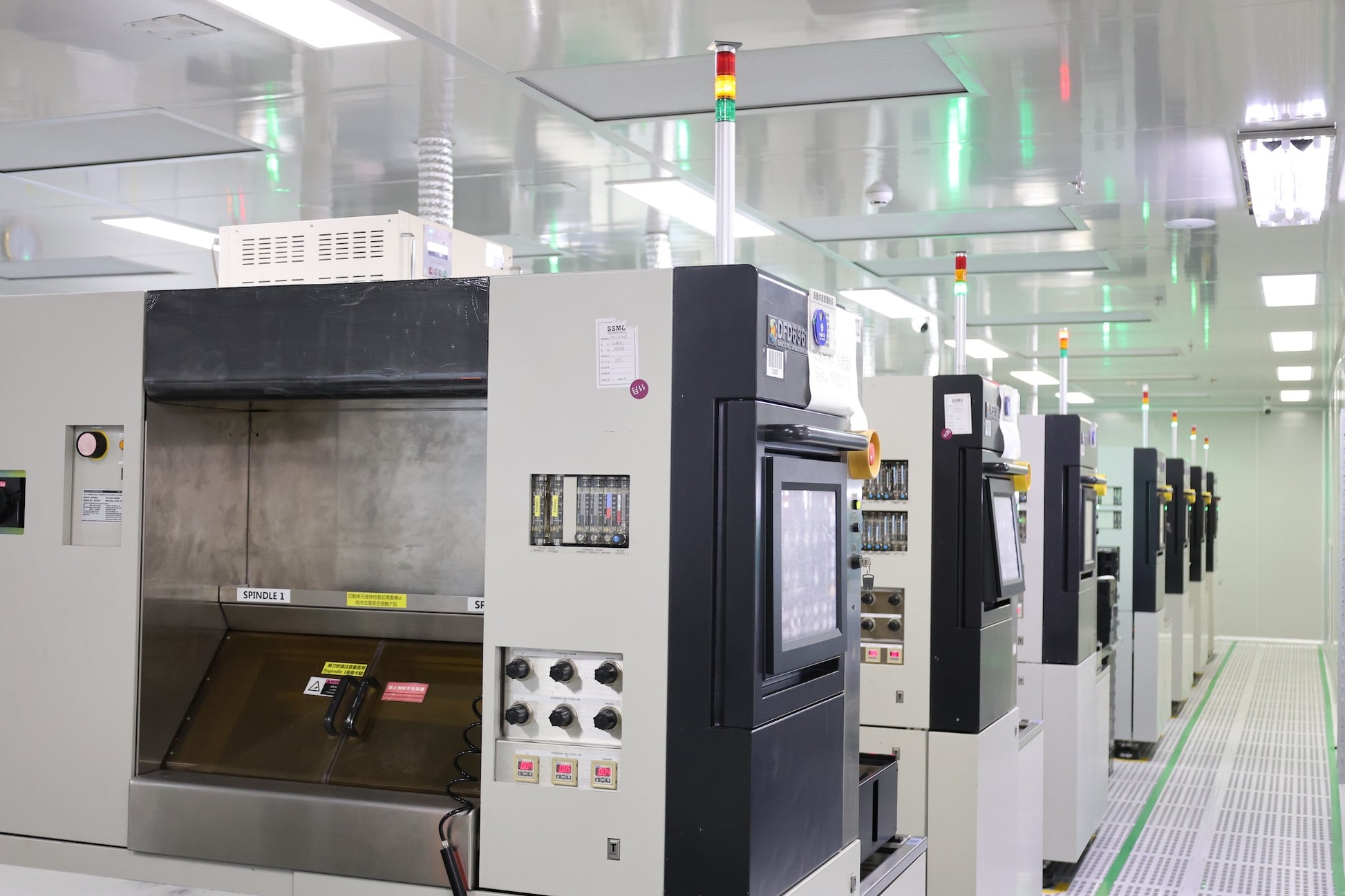 Industrial manufacturing machine with open chamber and control panels